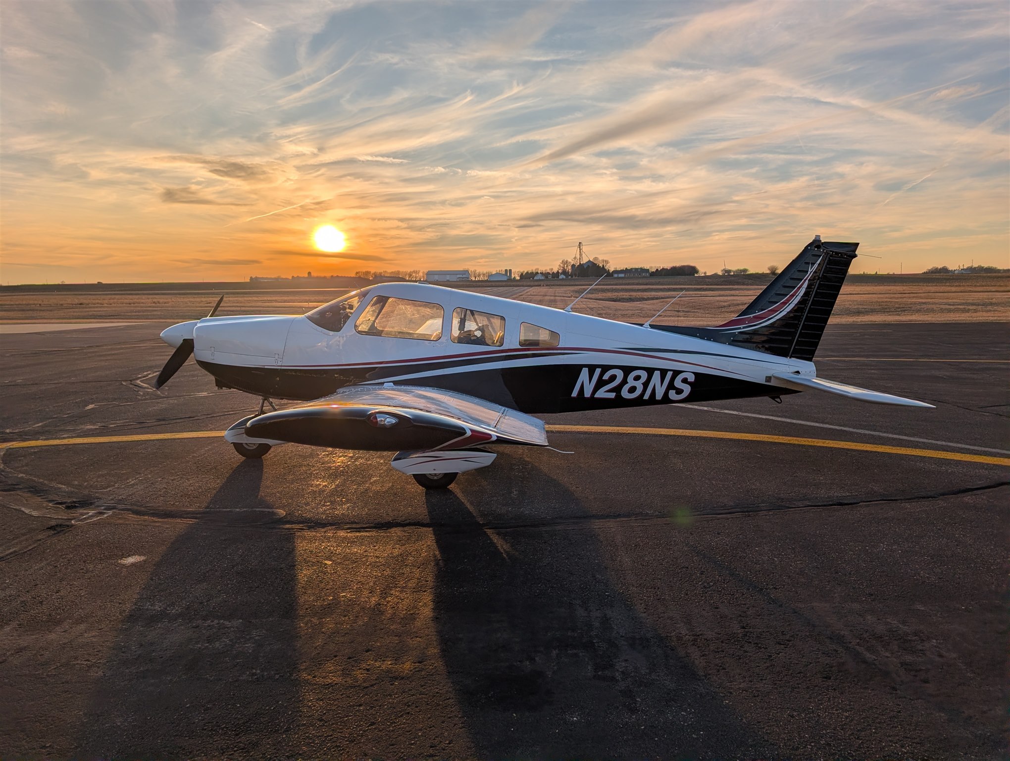 N28NS parked on the ramp beneath a colorful sunset